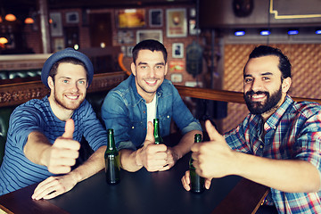 Image showing happy male friends drinking beer at bar or pub