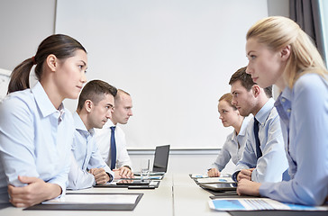 Image showing smiling business people having conflict in office