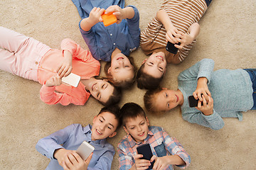 Image showing happy smiling children lying on floor in circle