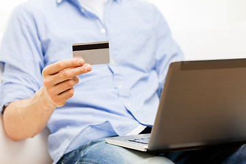 Image showing close up of man with laptop and credit card