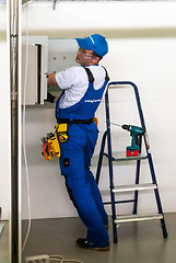 Image showing Young electrician performs task of competition