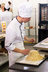 Image showing Young cook prepares food in competition