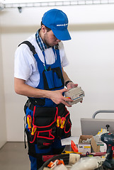 Image showing Young electrician performs task of competition