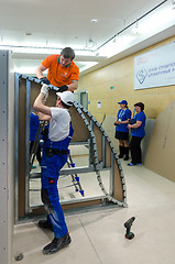 Image showing Young workers performs task with gypsum cardboard