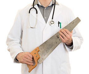 Image showing Crazy doctor is holding a big saw in his hands