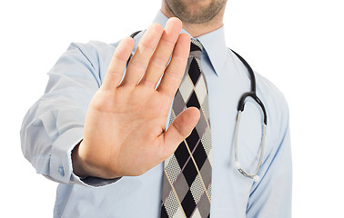Image showing Male doctor holding up his hand in a Halt or Stop gesture