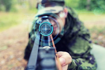 Image showing close up of soldier or sniper with gun in forest