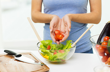 Image showing close up of woman cooking vegetable salad at home
