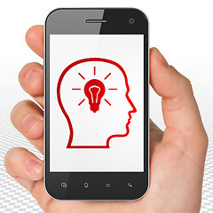 Image showing Information concept: Hand Holding Smartphone with Head With Lightbulb on display