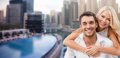 Image showing happy couple having fun over dubai city background