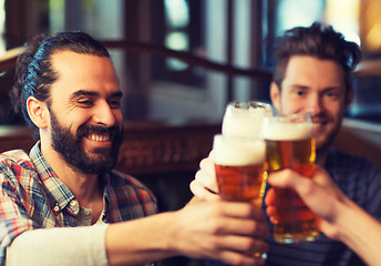 Image showing happy male friends drinking beer at bar or pub