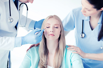 Image showing plastic surgeon and nurse with patient