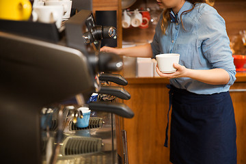 Image showing close up of woman making coffee by machine at cafe