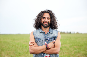 Image showing smiling young hippie man on green field