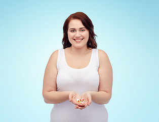 Image showing happy plus size woman in underwear with pills