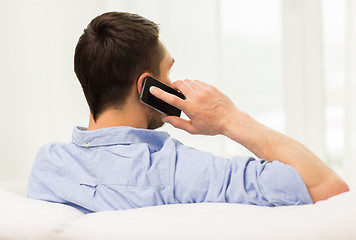 Image showing close up of man calling on smartphone at home