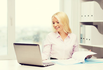 Image showing smiling businesswoman or student with laptop