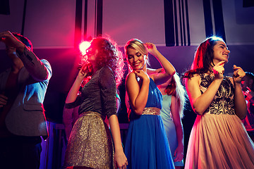 Image showing smiling friends dancing in club