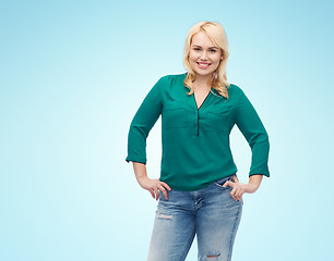 Image showing smiling young woman in shirt and jeans