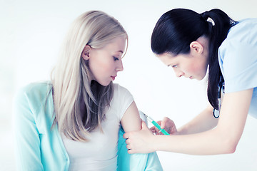 Image showing doctor doing vaccine to patient