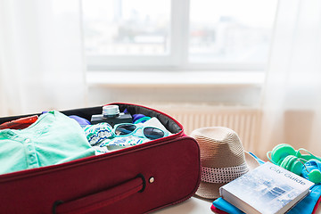 Image showing close up of travel bag with clothes and stuff