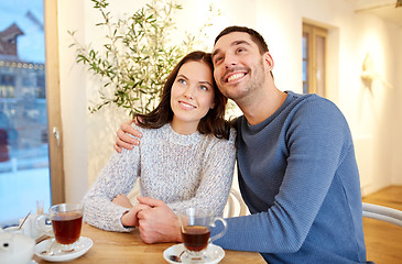 Image showing happy couple drinking tea at restaurant