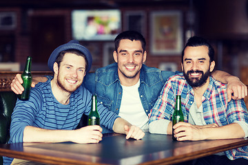 Image showing happy male friends drinking beer at bar or pub