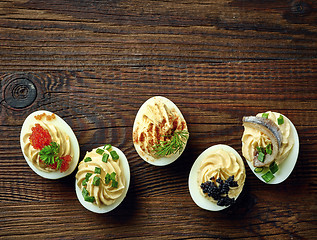 Image showing stuffed eggs on wooden table