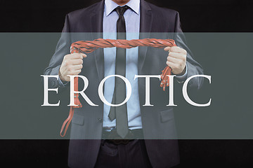 Image showing man in business suit with chained hands. handcuffs for sex games. concept of erotic entertainment. erotic