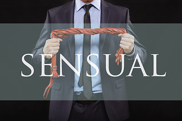Image showing man in business suit with chained hands. handcuffs for sex games. concept of erotic entertainment. sensual