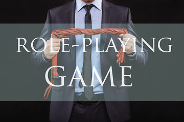 Image showing man in business suit with chained hands. handcuffs for sex games. concept of erotic entertainment. role playing game