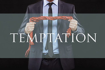 Image showing man in business suit with chained hands. handcuffs for sex games. concept of erotic entertainment. temptation