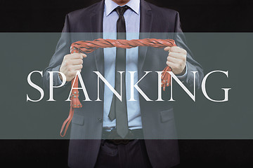 Image showing man in business suit with chained hands. handcuffs for sex games. concept of erotic entertainment.