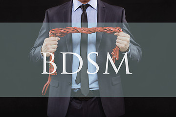 Image showing man in business suit with chained hands. handcuffs for sex games. concept of erotic entertainment.