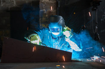 Image showing worker welding metal