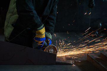 Image showing worker works with metal 