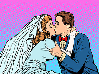 Image showing The bride and groom kiss