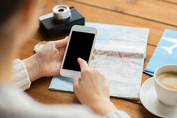 Image showing close up of traveler hands with smartphone and map