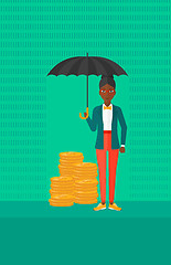 Image showing Woman with umbrella protecting money.