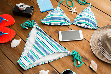 Image showing close up of smartphone and beach stuff