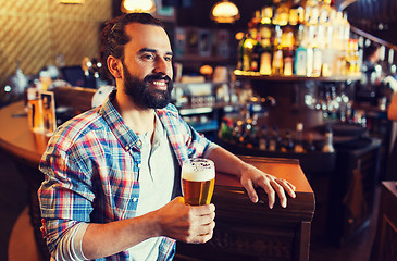 Image showing happy man drinking beer at bar or pub