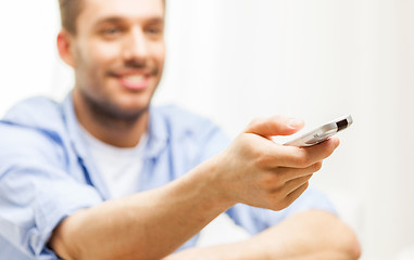 Image showing close up of man with tv remote control at home