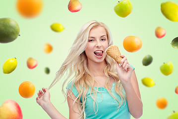 Image showing happy young woman in sunglasses eating ice cream