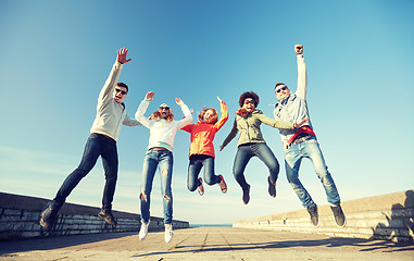 Image showing smiling friends in sunglasses laughing on street