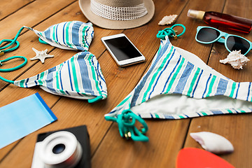 Image showing close up of smartphone and beach stuff