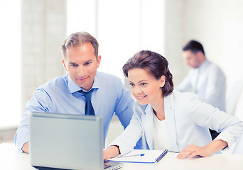 Image showing man and woman working with laptop in office