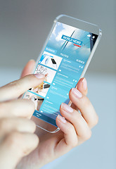 Image showing close up of woman with news pages on smartphone