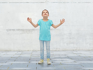 Image showing happy little girl looking up to something