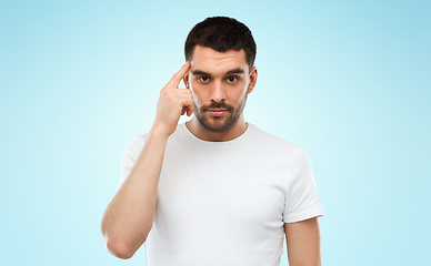 Image showing man with finger at temple over blue background