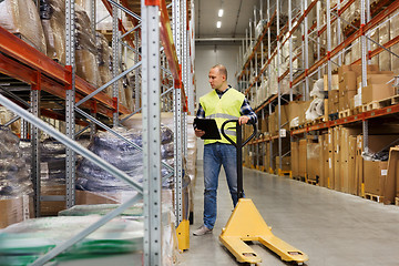 Image showing man with loader and clipboard at warehouse